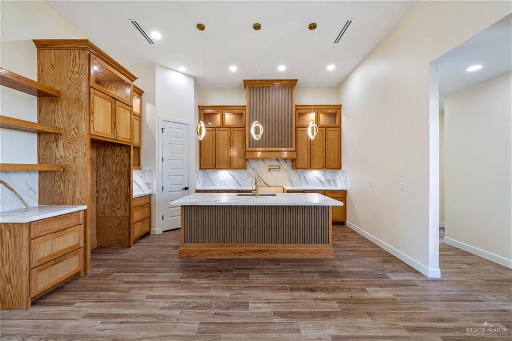 1602 Helen Drive Weslaco, TX 78596 - Photo 5 of 32 a view of kitchen with stainless steel appliances granite countertop cabinets and wooden floor