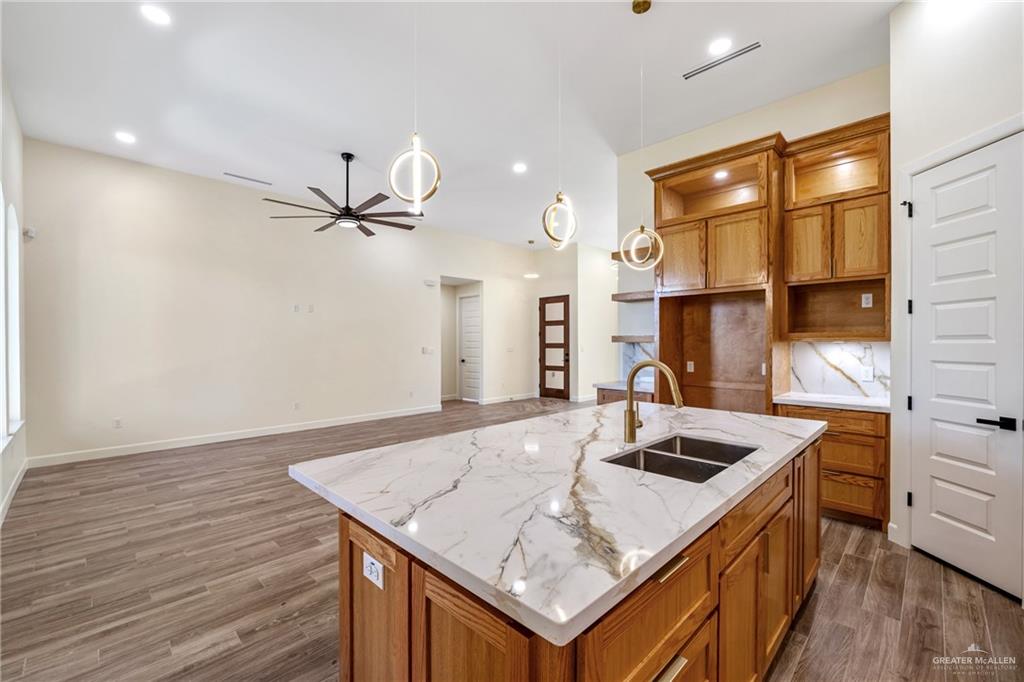 1602 Helen Drive Weslaco, TX 78596 - Photo 7 of 32 a kitchen with a sink a counter space and wooden floor