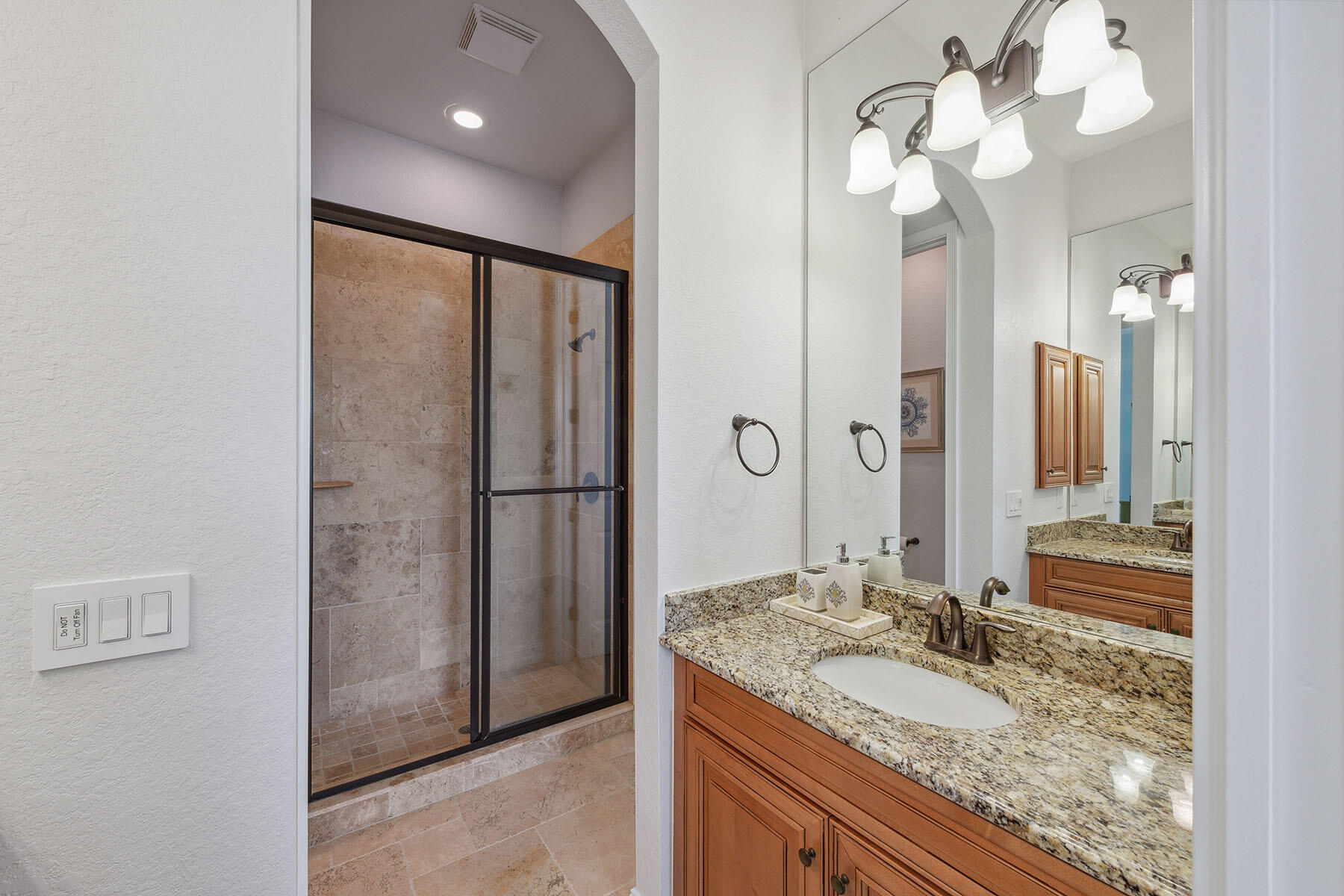 3441 Runaway Lane Naples, FL 34114 - Photo 25 of 50 a bathroom with a granite countertop sink a mirror and shower