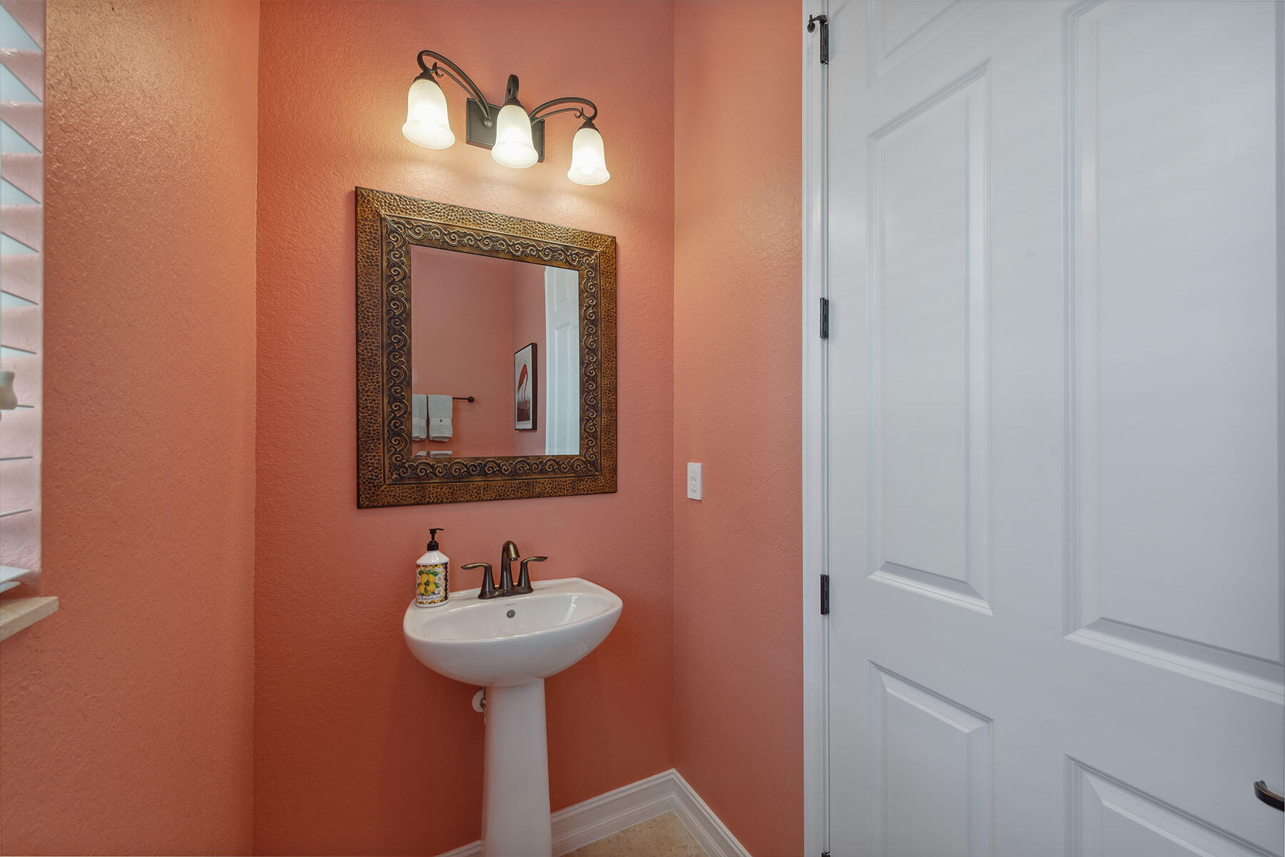3441 Runaway Lane Naples, FL 34114 - Photo 28 of 50 a bathroom with a sink and a mirror