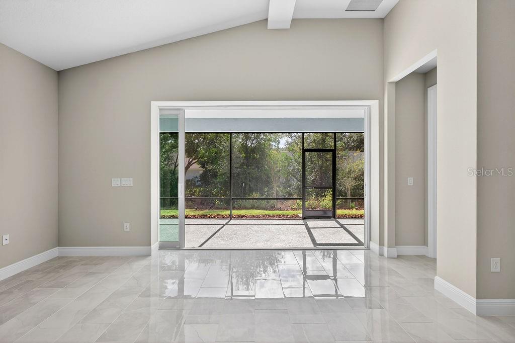 2046 Wallingford Loop Mount Mount Dora, FL 32757 - Photo 16 of 55 a view of an empty room with glass door