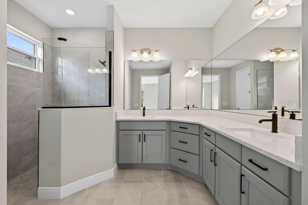 2046 Wallingford Loop Mount Mount Dora, FL 32757 - Photo 19 of 55 a spacious bathroom with a double vanity sink and a mirror