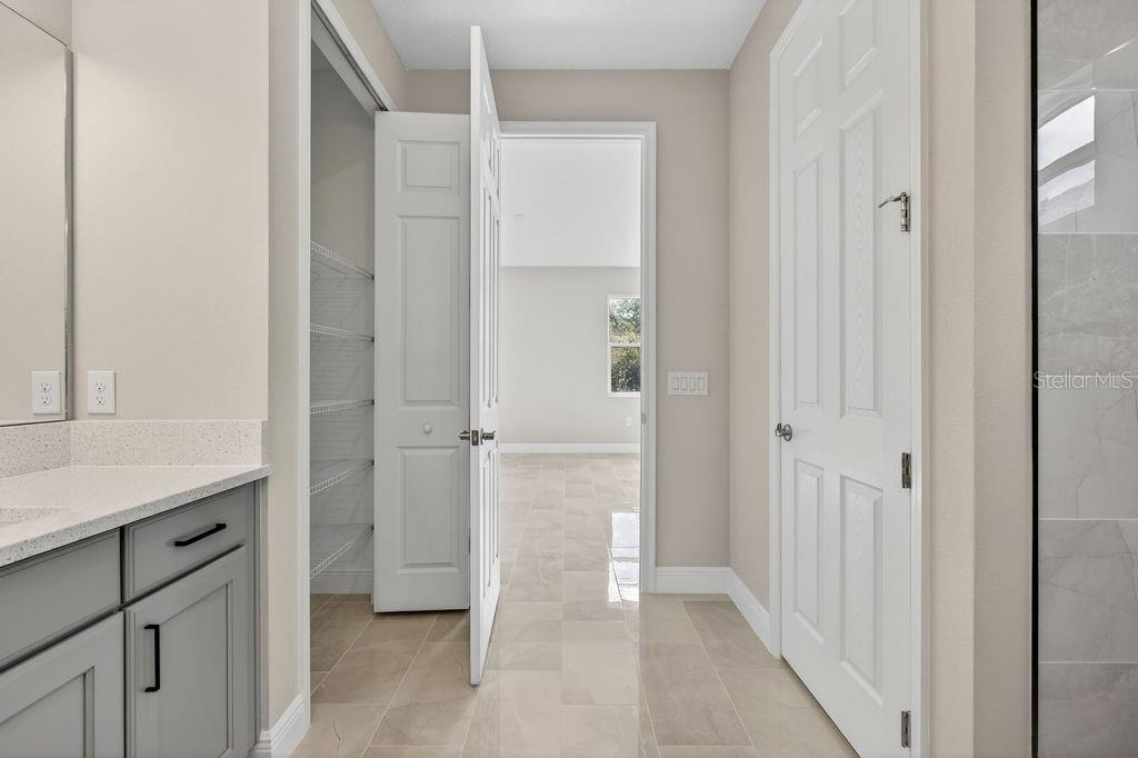 2046 Wallingford Loop Mount Mount Dora, FL 32757 - Photo 20 of 55 a view of a bathroom with a shower and a sink