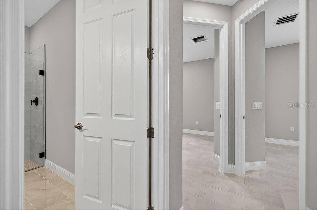 2046 Wallingford Loop Mount Mount Dora, FL 32757 - Photo 22 of 55 a view of a bathroom with a glass door