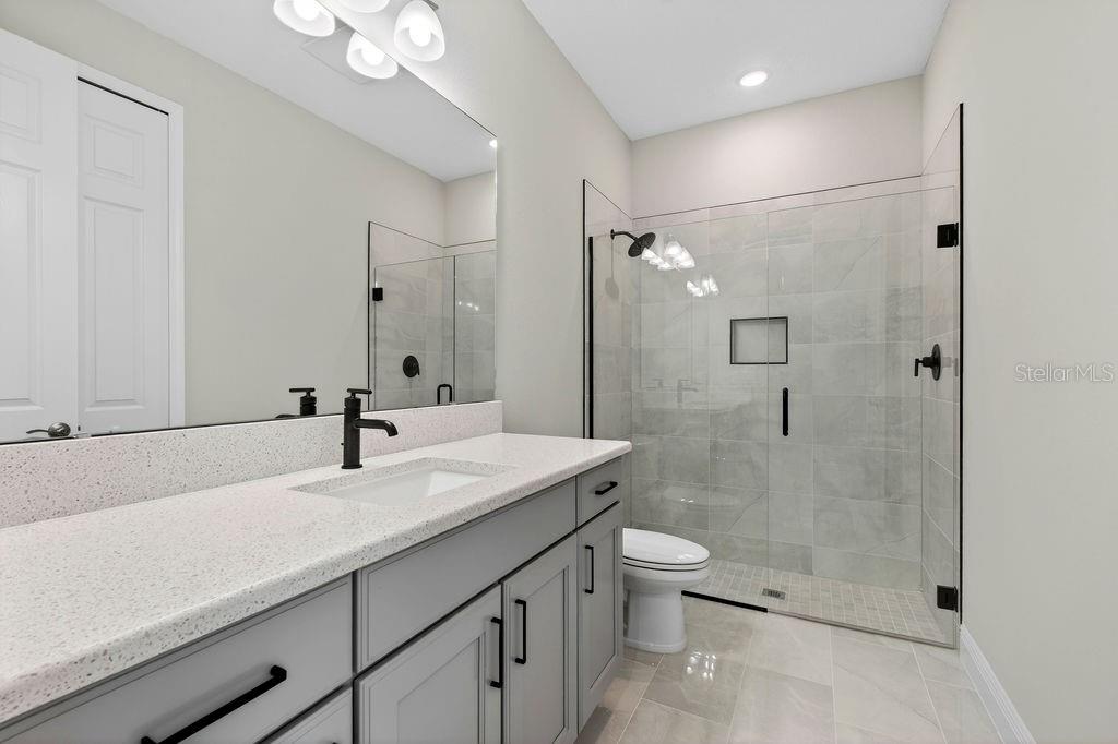 2046 Wallingford Loop Mount Mount Dora, FL 32757 - Photo 29 of 55 a bathroom with a sink a toilet and shower