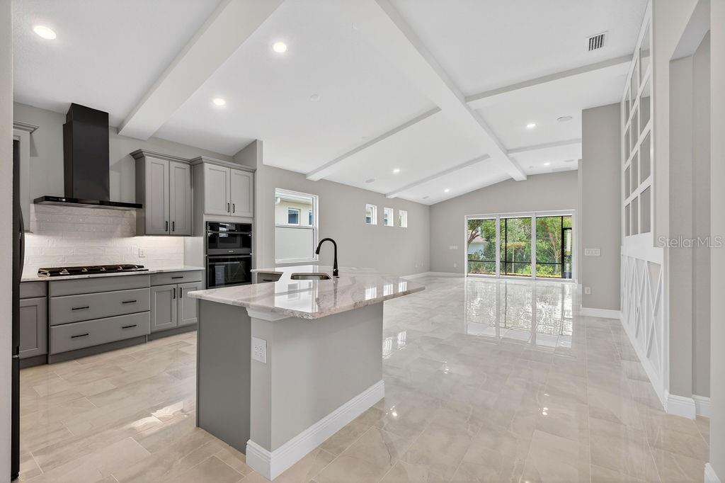 2046 Wallingford Loop Mount Mount Dora, FL 32757 - Photo 7 of 55 a large kitchen with stainless steel appliances kitchen island granite countertop a sink and cabinets
