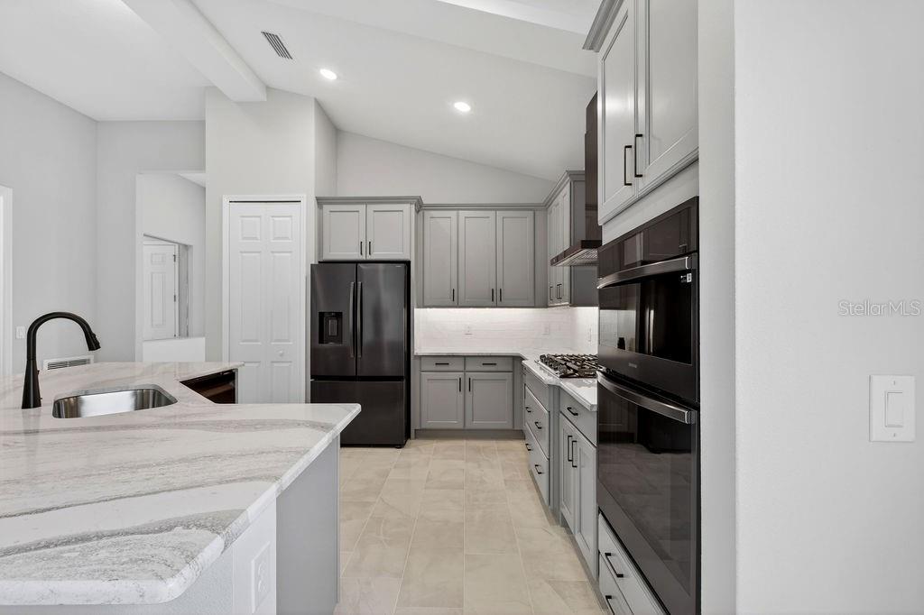 2046 Wallingford Loop Mount Mount Dora, FL 32757 - Photo 8 of 55 a kitchen with a refrigerator sink and stove