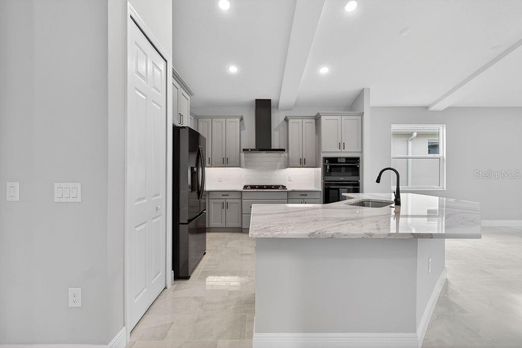 2046 Wallingford Loop Mount Mount Dora, FL 32757 - Photo 9 of 55 a view of kitchen with sink refrigerator and cabinets