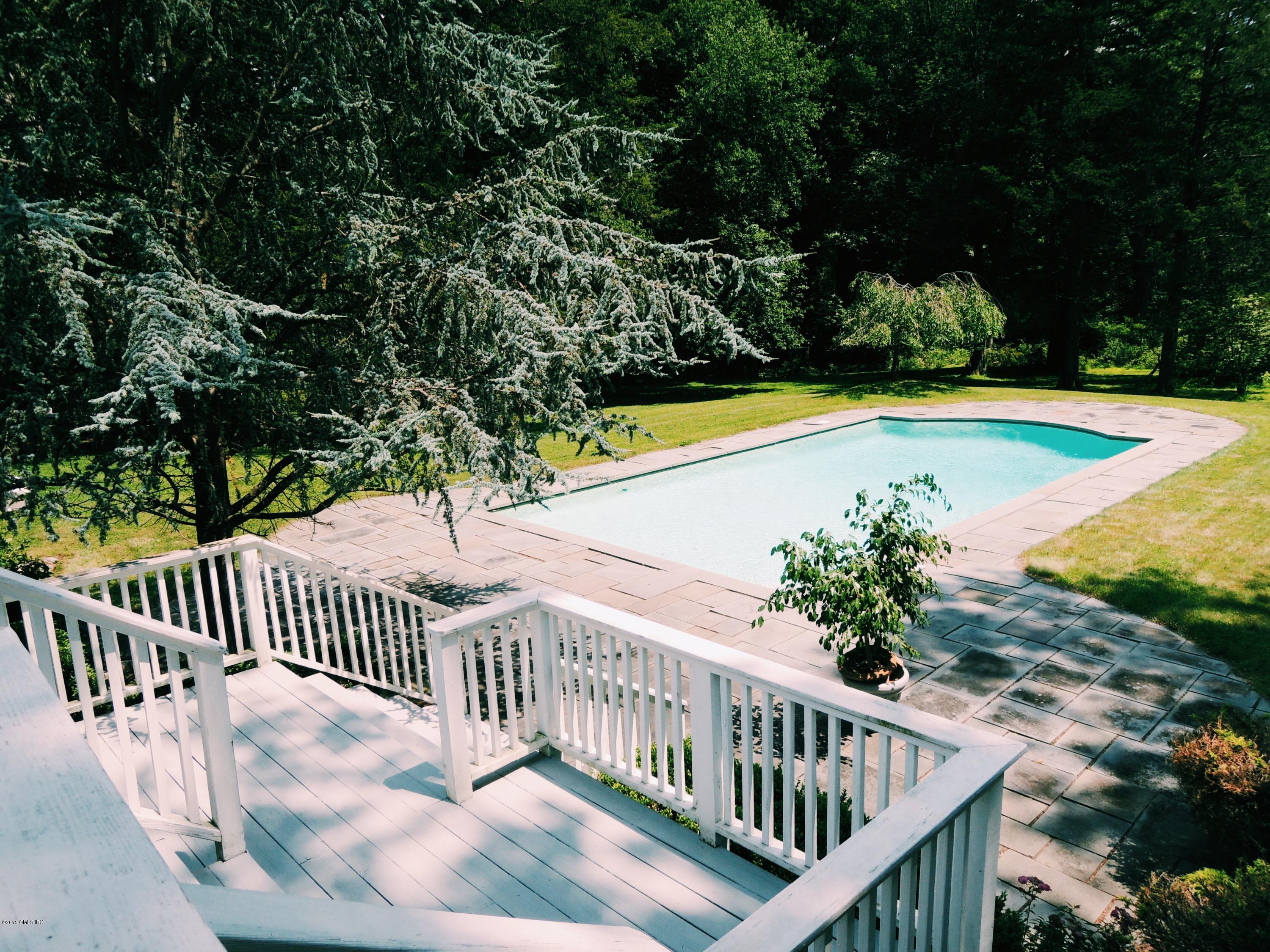 74 Howard Road Greenwich, CT 06831 - Photo 14 of 25 a view of a swimming pool with deck and garden