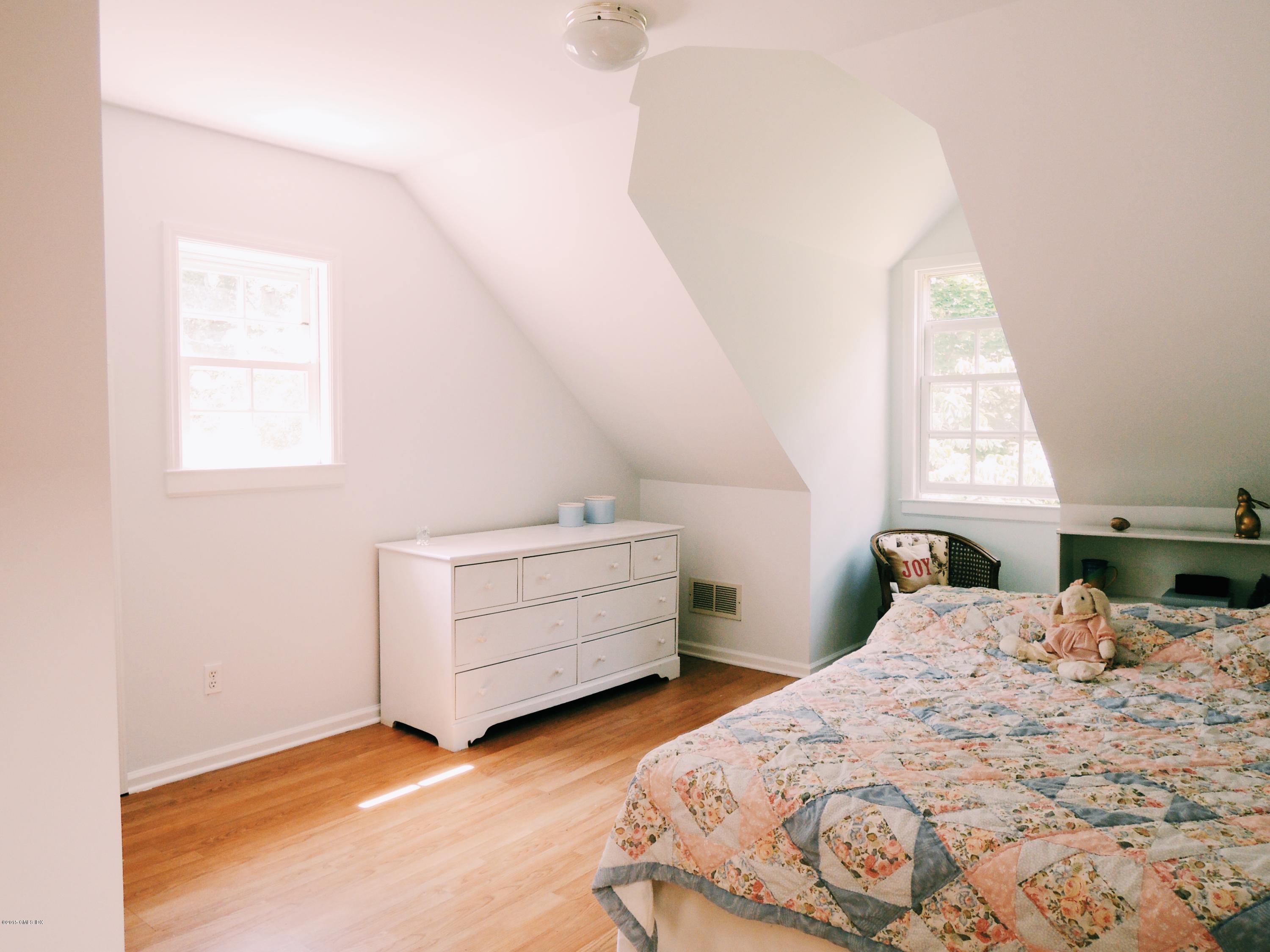 74 Howard Road Greenwich, CT 06831 - Photo 18 of 25 a bedroom with a bed and a window