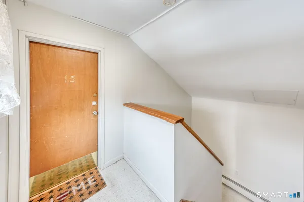 a view of room with window and wooden floor