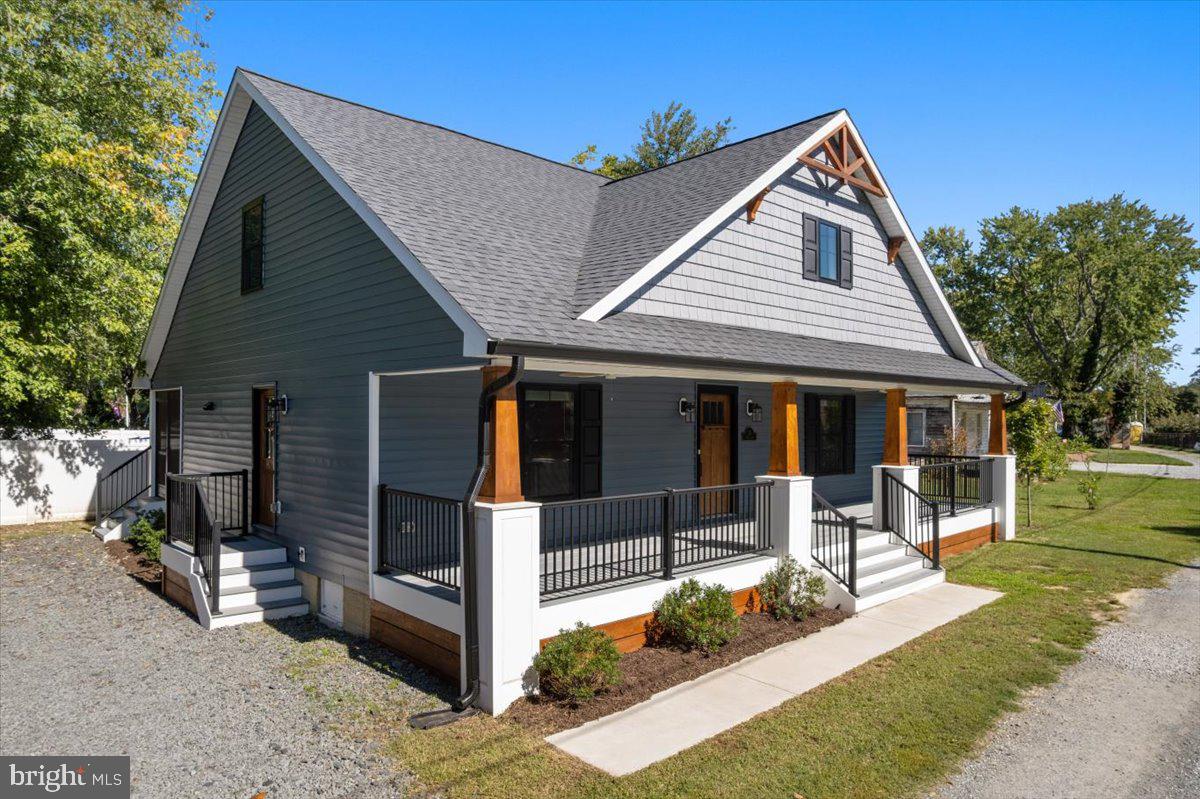a front view of a house with a yard table and chairs