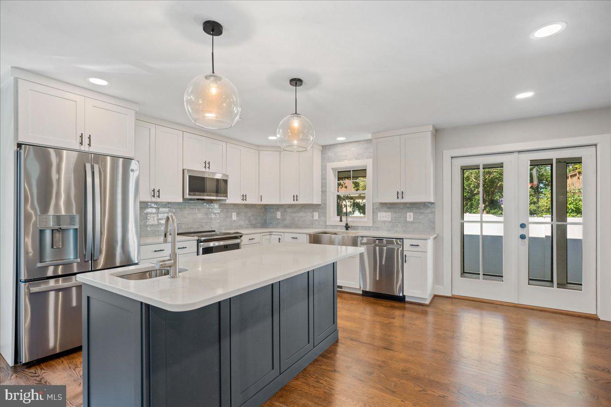 206 Point Lane Solomons, MD 20688 - Photo 12 of 46 a kitchen with kitchen island granite countertop appliances cabinets and a counter space