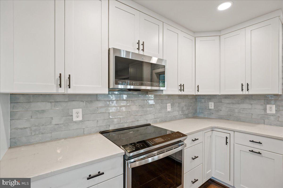 206 Point Lane Solomons, MD 20688 - Photo 13 of 46 a kitchen with granite countertop a sink a stove and microwave