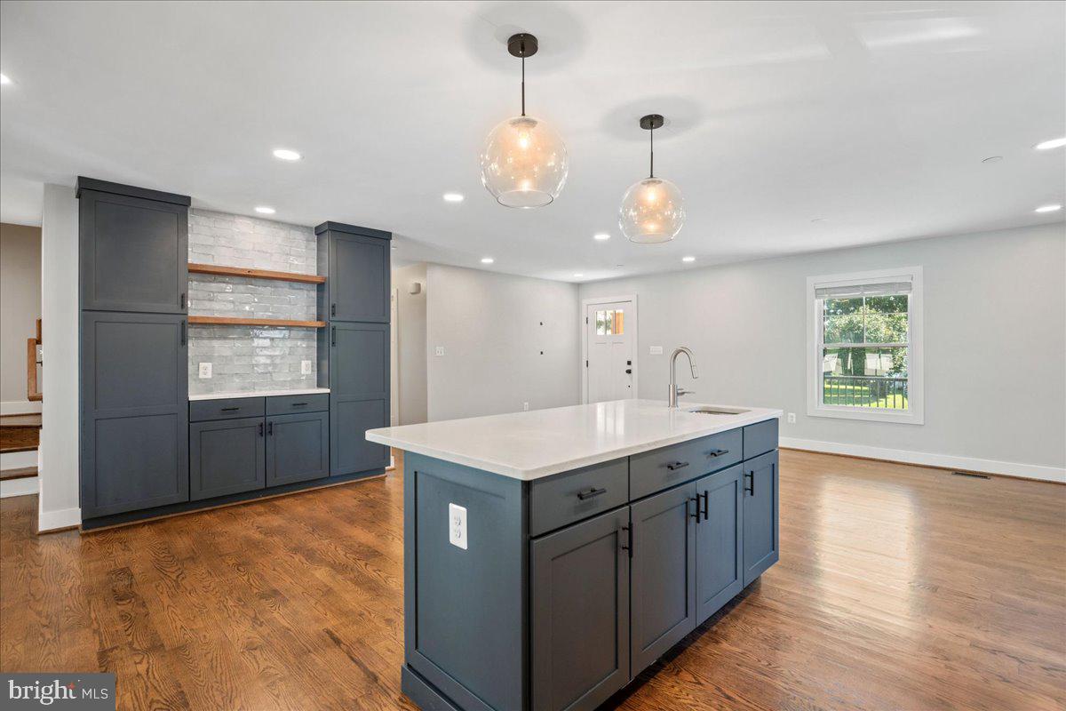 206 Point Lane Solomons, MD 20688 - Photo 15 of 46 a kitchen with kitchen island granite countertop a stove a sink a dining table and chairs