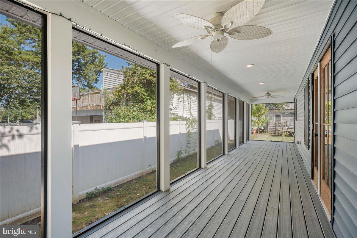 206 Point Lane Solomons, MD 20688 - Photo 17 of 46 a view of hallway with a large window and wooden floor