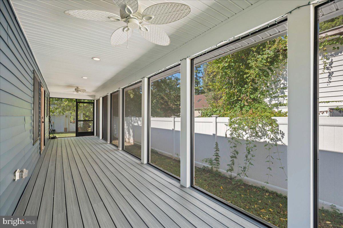 206 Point Lane Solomons, MD 20688 - Photo 18 of 46 a view of a room with wooden floor ceiling fan and windows