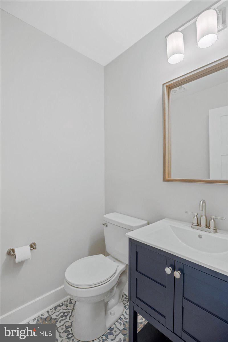206 Point Lane Solomons, MD 20688 - Photo 19 of 46 a bathroom with a sink toilet and mirror