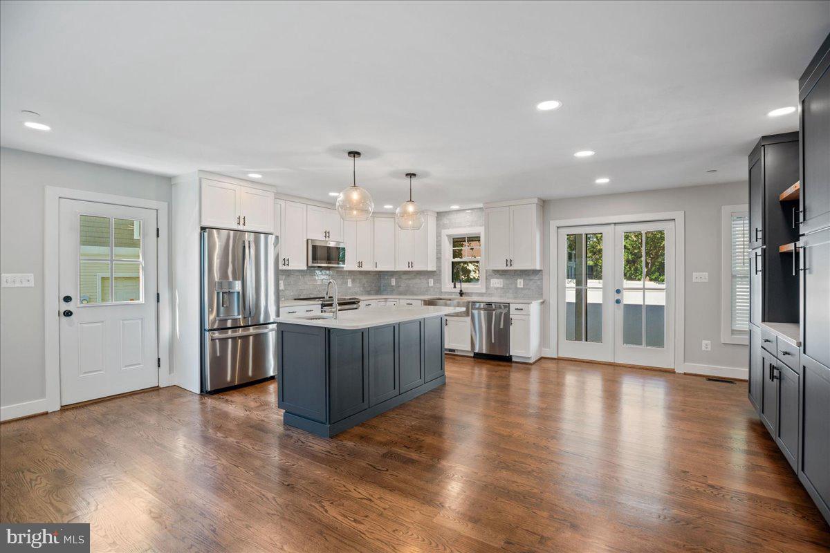206 Point Lane Solomons, MD 20688 - Photo 6 of 46 a large open kitchen with a refrigerator a sink dishwasher and a stove with wooden floor
