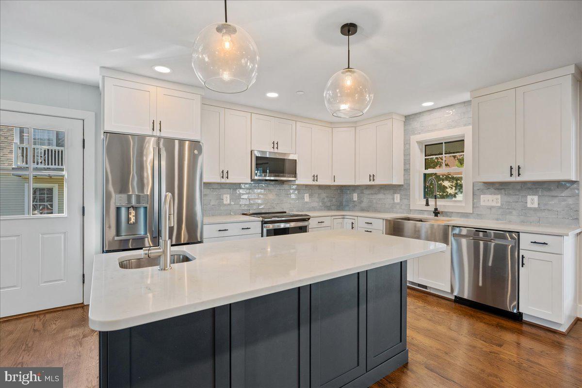 206 Point Lane Solomons, MD 20688 - Photo 8 of 46 a kitchen with stainless steel appliances granite countertop a sink refrigerator and cabinets