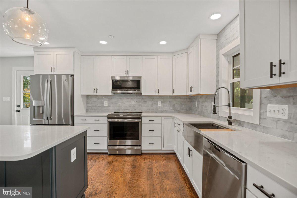 206 Point Lane Solomons, MD 20688 - Photo 9 of 46 a kitchen with stainless steel appliances granite countertop a sink stove and refrigerator