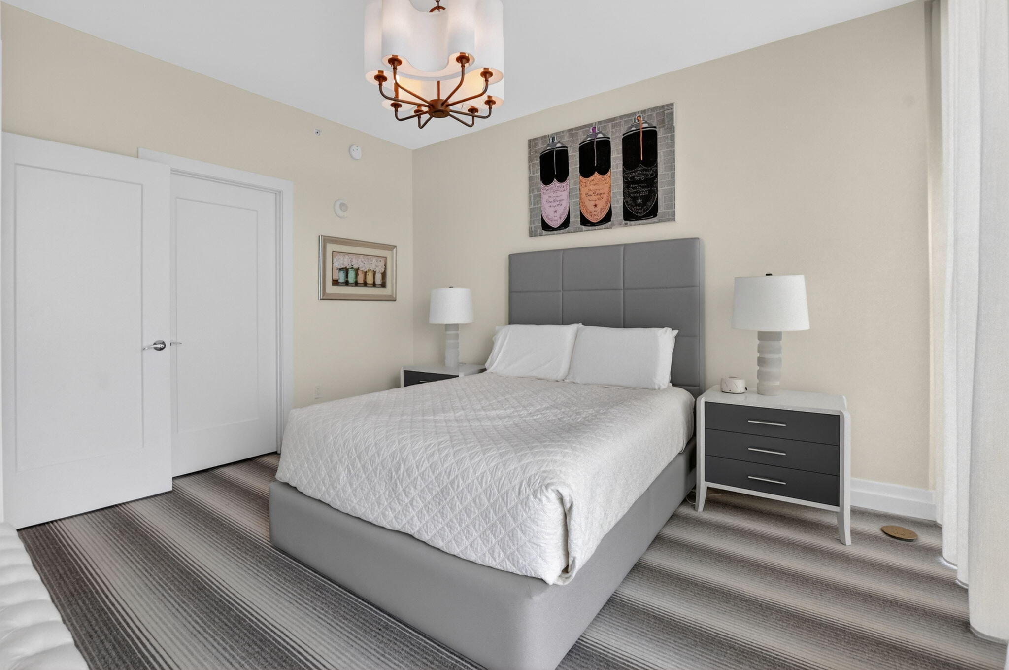 20155 Boca W Drive, Unit B701 Boca Raton, FL 33434 - Photo 27 of 78 a bedroom with a bed and a chandelier
