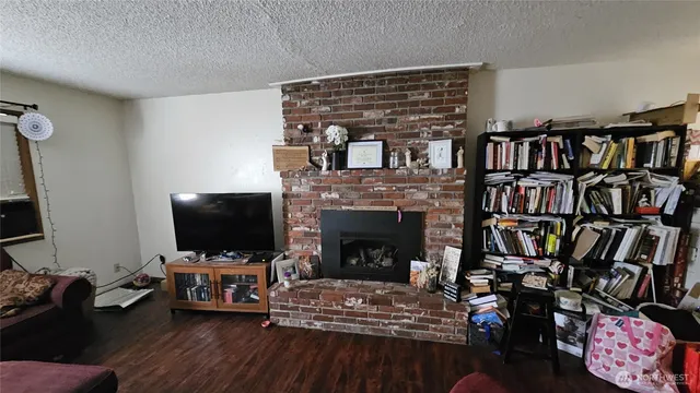 a living room with fireplace furniture and a flat screen tv