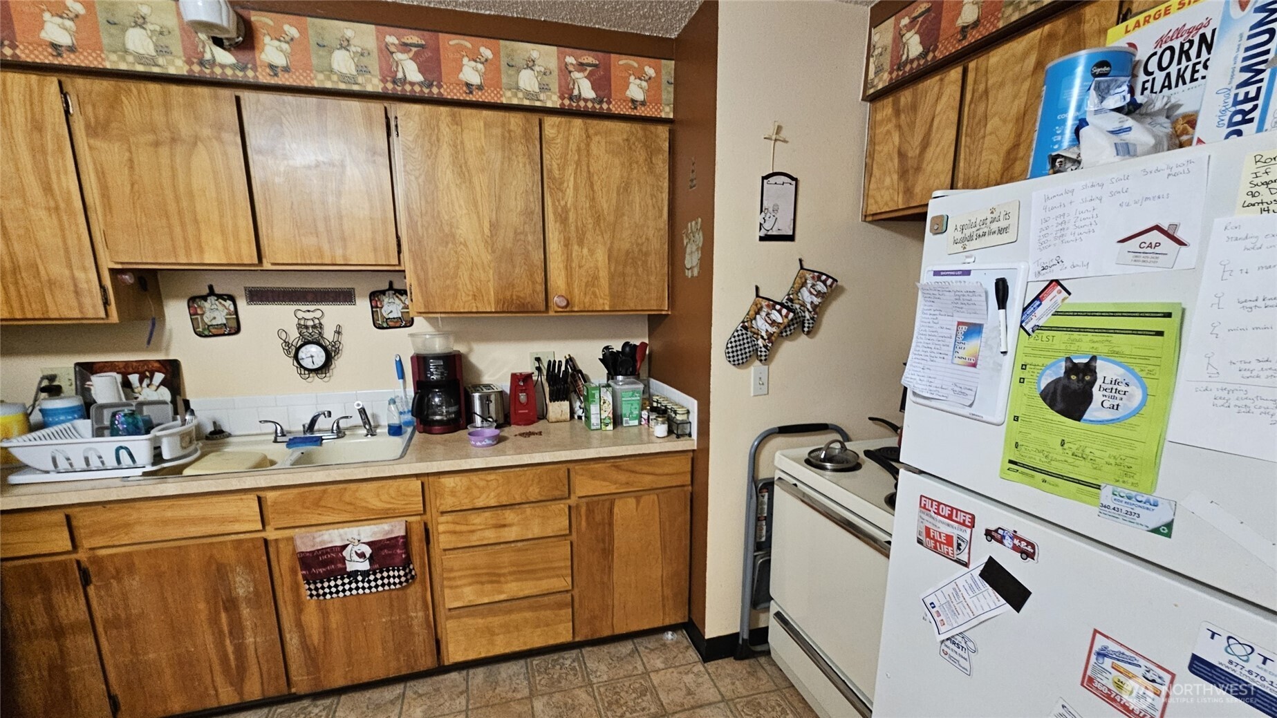 1023 16th Avenue Longview, WA 98632 - Photo 7 of 10 a kitchen with stainless steel appliances granite countertop a refrigerator and a stove top oven