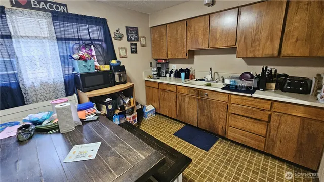a kitchen that has a lot of cabinets a sink and a stove in it