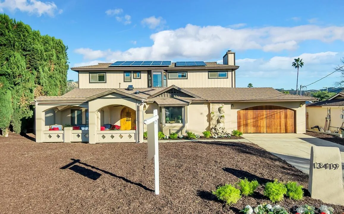 an aerial view of a house with a yard