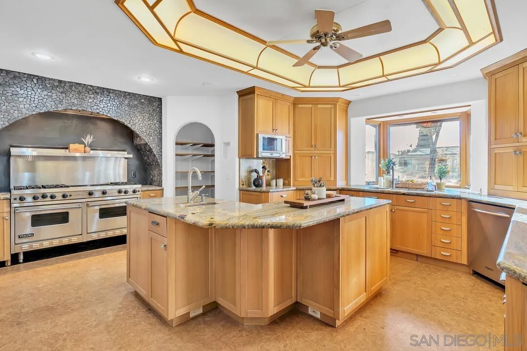 13419 Sebago Avenue Poway, CA 92064 - Photo 15 of 49 a kitchen with stainless steel appliances granite countertop a stove and a sink