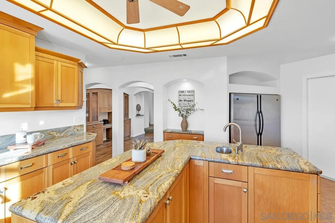 13419 Sebago Avenue Poway, CA 92064 - Photo 20 of 49 a large kitchen with stainless steel appliances granite countertop a sink and cabinets
