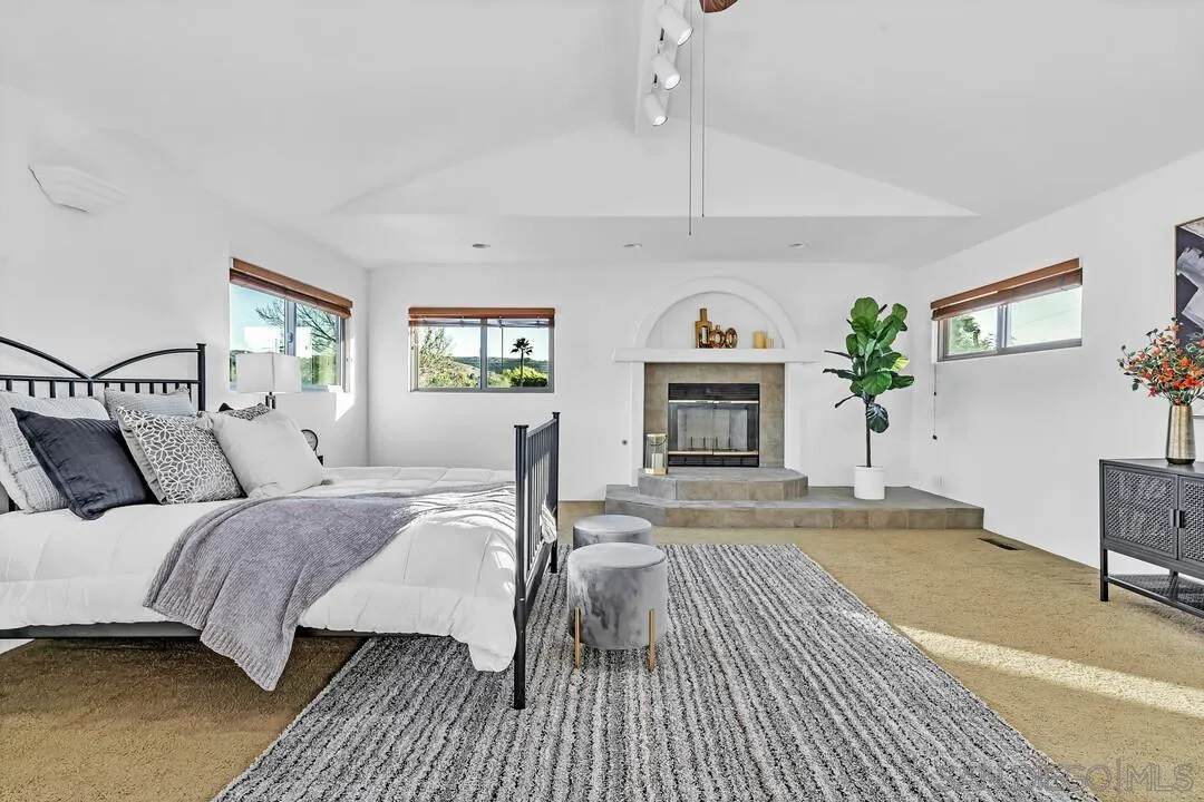 13419 Sebago Avenue Poway, CA 92064 - Photo 38 of 49 a bedroom with a bed and a fireplace