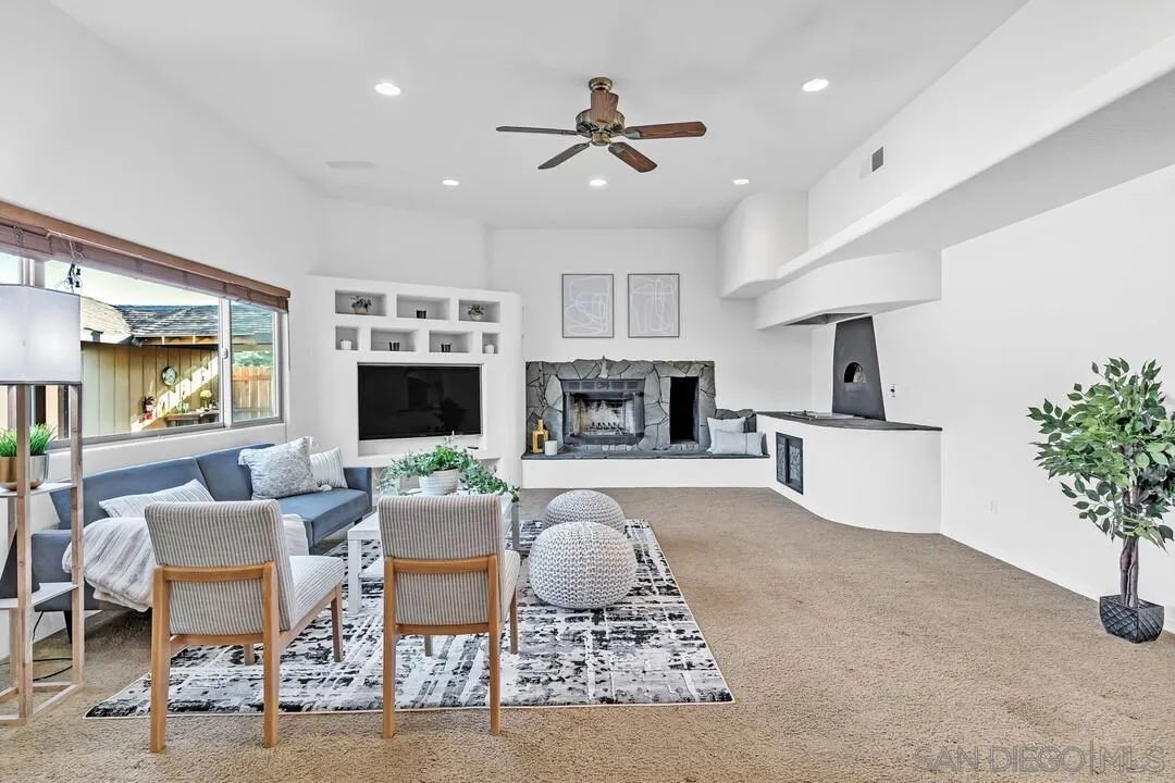 13419 Sebago Avenue Poway, CA 92064 - Photo 8 of 49 a living room with furniture a fireplace and a flat screen tv