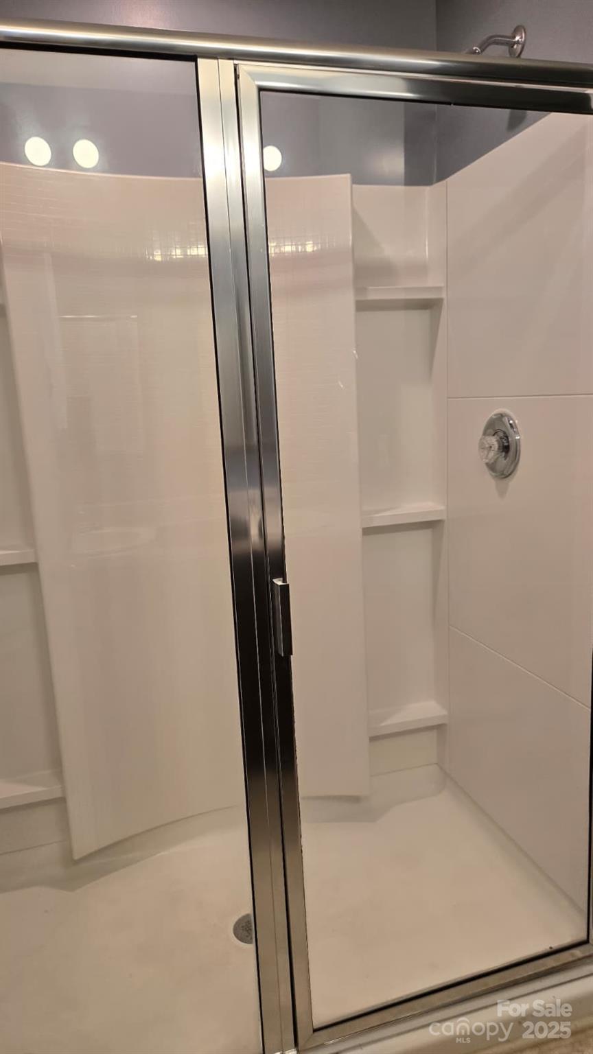 705 Anglin Forest Way Charlotte, NC 28214 - Photo 19 of 36 a bathroom with a glass shower door