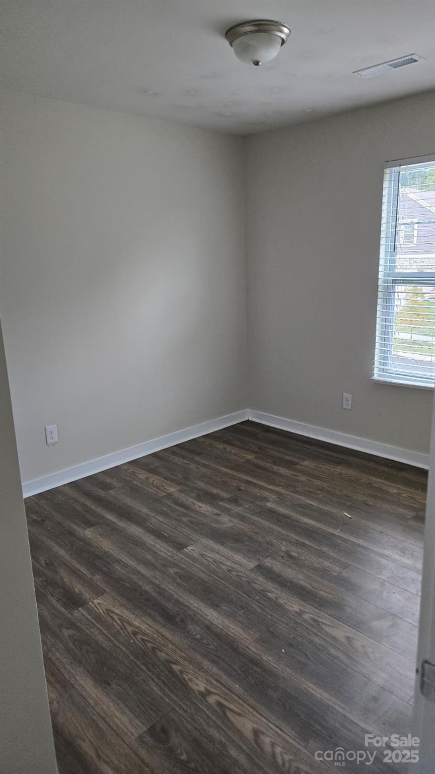 705 Anglin Forest Way Charlotte, NC 28214 - Photo 21 of 36 an empty room with wooden floor and windows