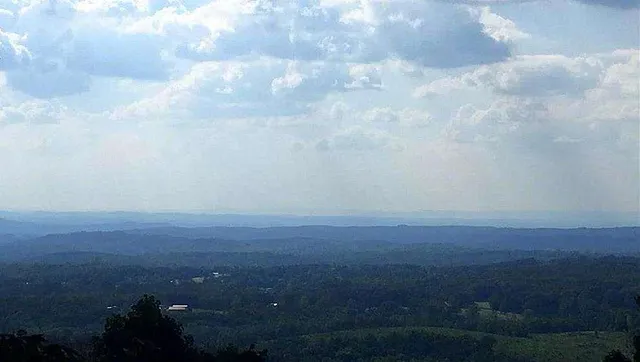 a view of yard and mountain in back
