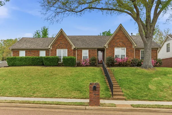 a front view of a house with a yard