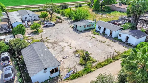 an aerial view of a house with a yard and lake view