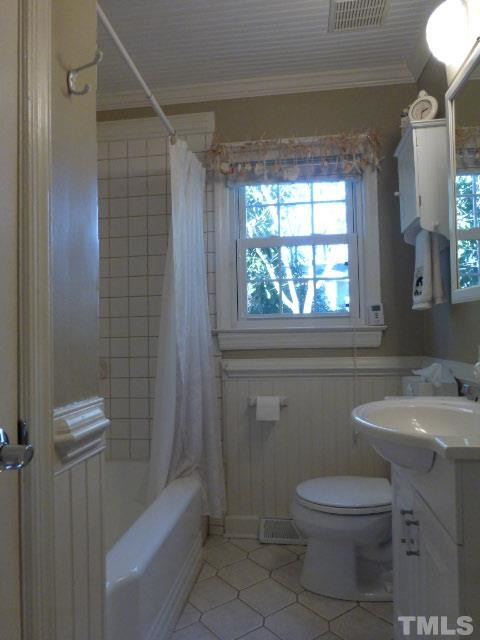 1216 Brookside Drive Raleigh, NC 27604 - Photo 15 of 24 The original bath has been extensively remodel with tile floors and surrounds.