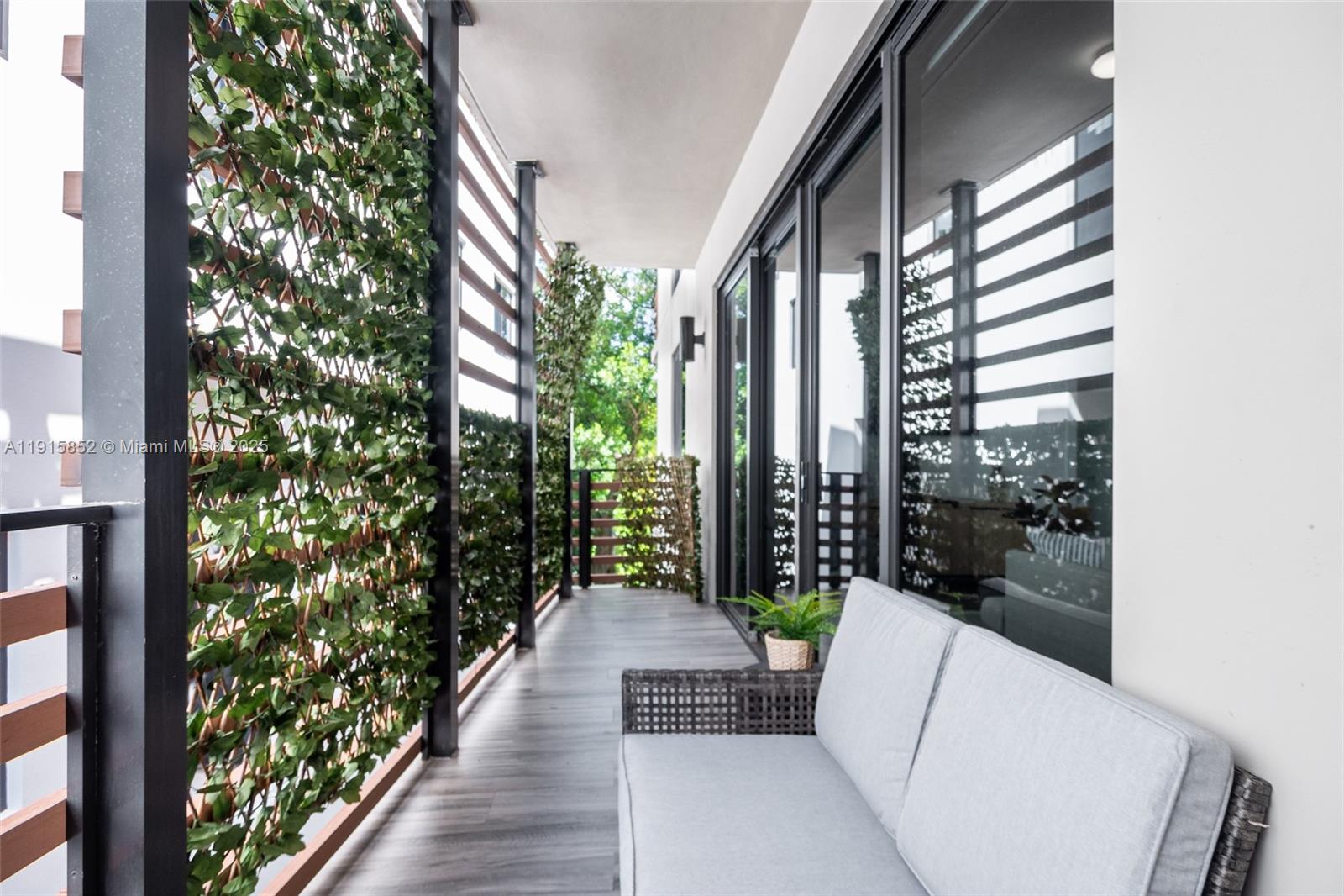 2955 Bird Avenue, Unit 2B Miami, FL 33133 - Photo 12 of 16 a porch with a bench and potted plants