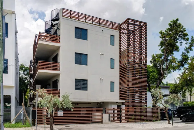 a front view of a house with plants