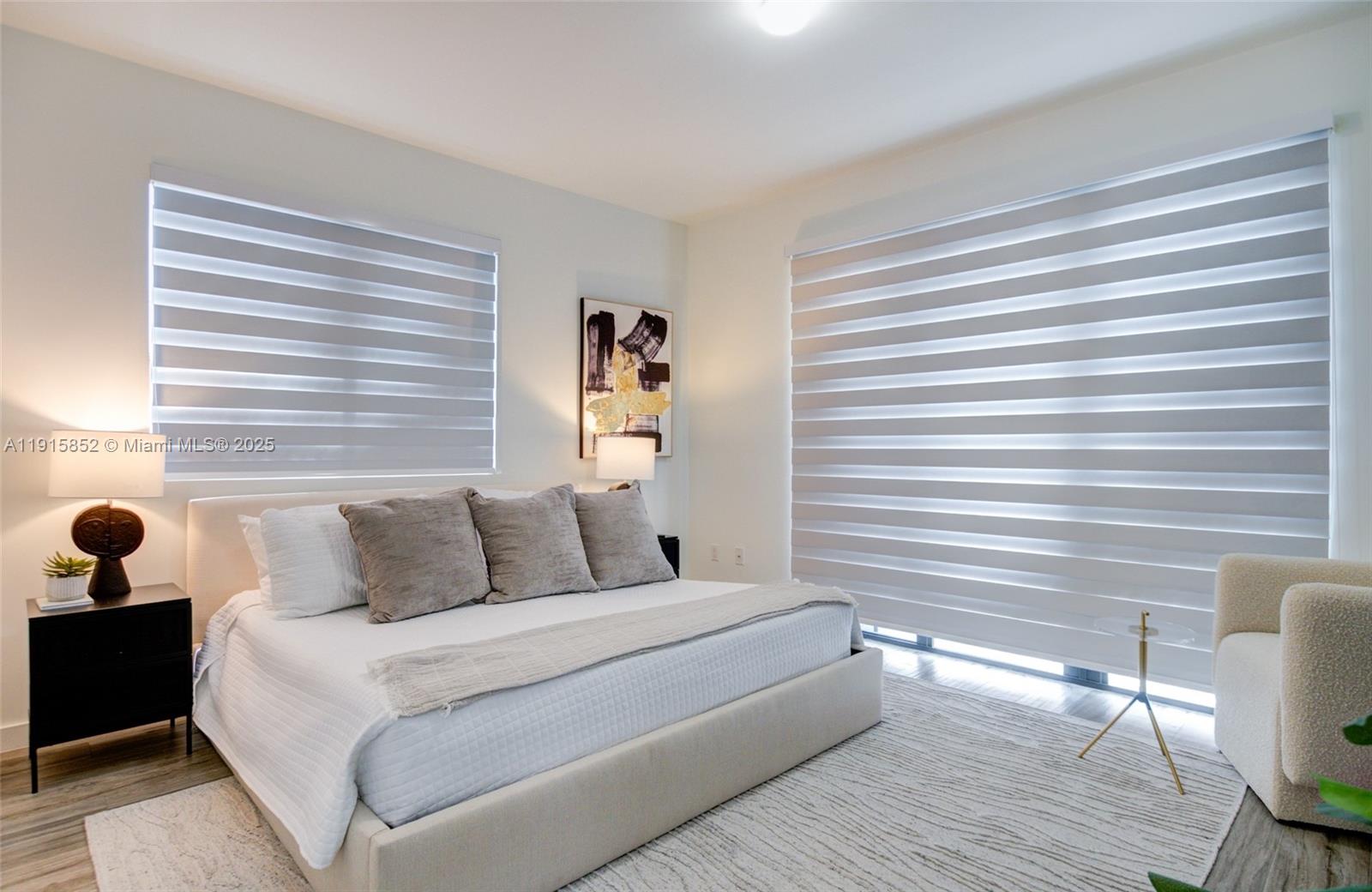 2955 Bird Avenue, Unit 2B Miami, FL 33133 - Photo 6 of 16 a bedroom with a bed and wooden floor