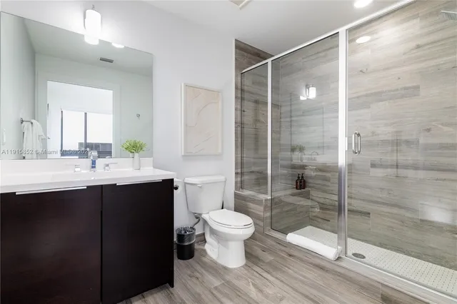 a bathroom with a sink toilet and shower