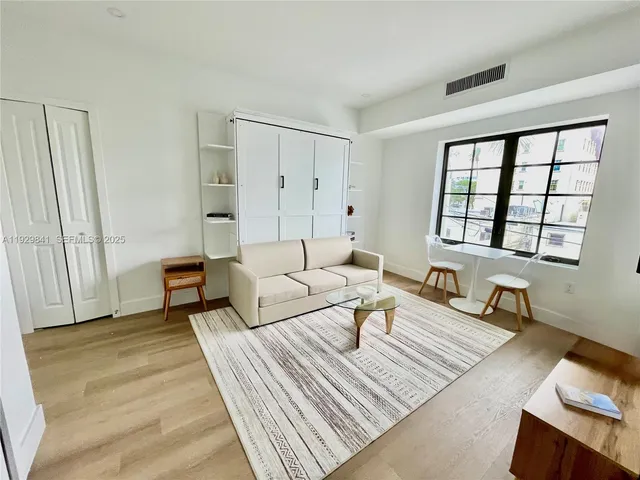 a living room with furniture and a window