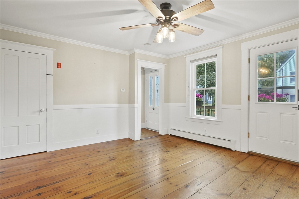 4 Winter Street, Unit 4 Amesbury, MA 01913 - Photo 11 of 39 an empty room with wooden floor fan and windows