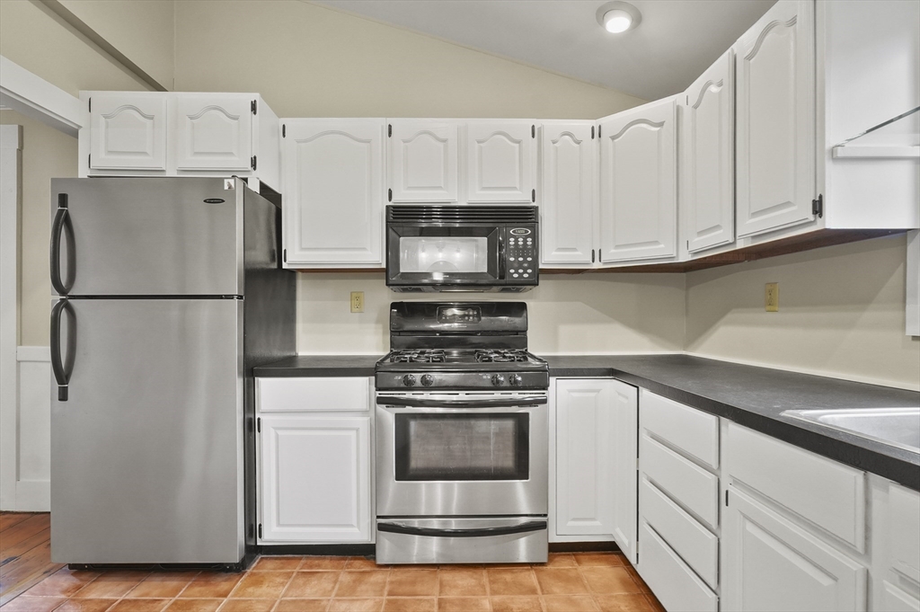 4 Winter Street, Unit 4 Amesbury, MA 01913 - Photo 13 of 39 a kitchen with white cabinets and white appliances