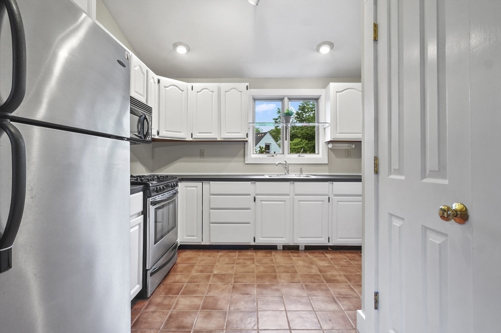 4 Winter Street, Unit 4 Amesbury, MA 01913 - Photo 14 of 39 a kitchen with white cabinets and appliances