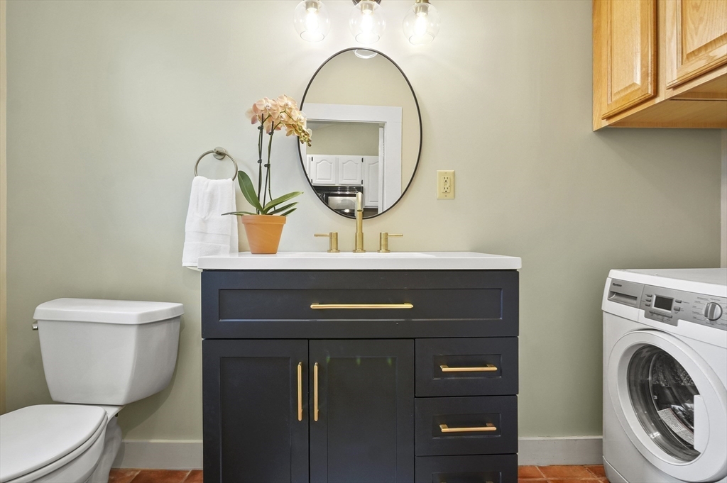4 Winter Street, Unit 4 Amesbury, MA 01913 - Photo 17 of 39 a bathroom with a toilet a sink and a mirror