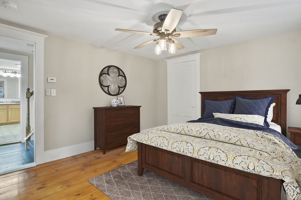 4 Winter Street, Unit 4 Amesbury, MA 01913 - Photo 18 of 39 a bedroom with a bed a mirror and a window